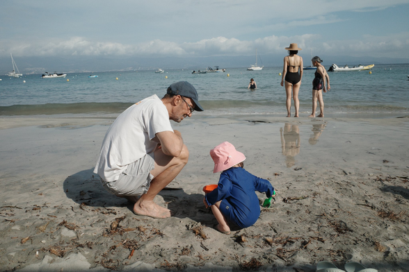 My father and my daughter on a beach with my partner and her grandmother in the background