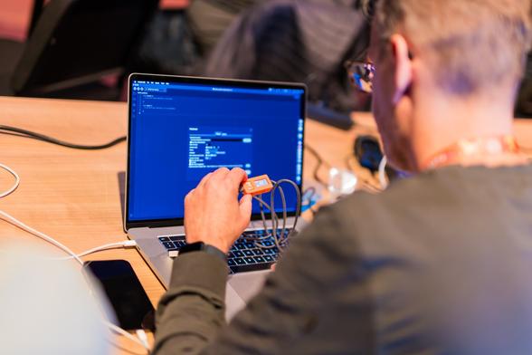 An event attendee configures a sensor during a workshop.