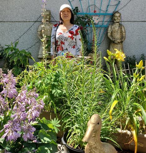 Mom standing amidst our Chinese themed front gardens.