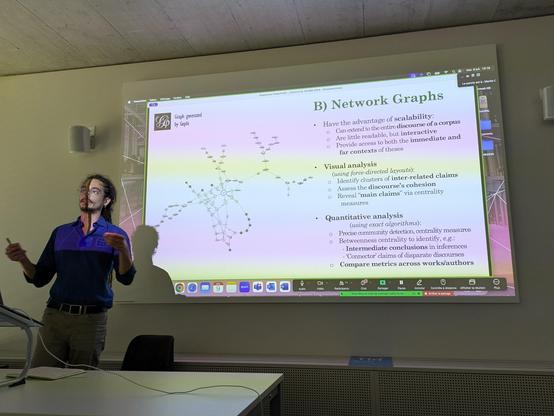 Daniele in from of a slide with a Gephi network map.