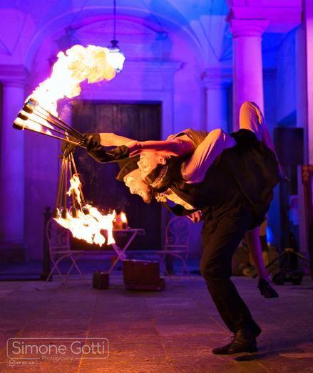 A man and a woman dancing with fire
