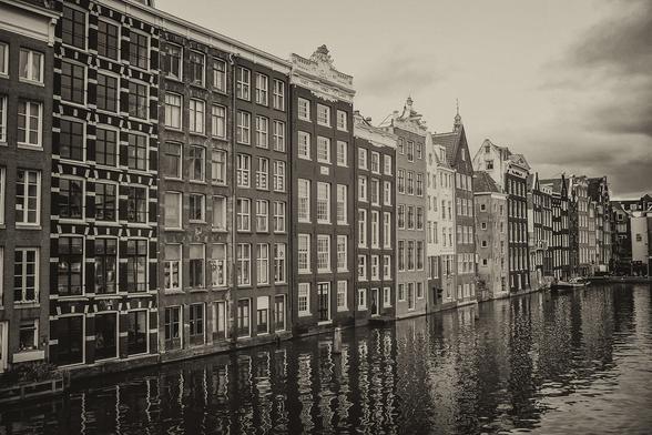Old houses on a canal in Amsterdam. Vintage sepia toning