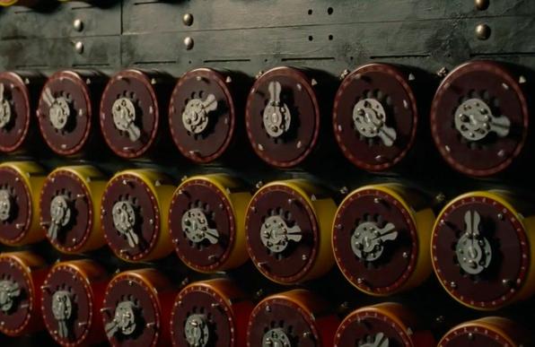 A close-up of several rows of spinning mechanical dials, part of the Enigma computing machine