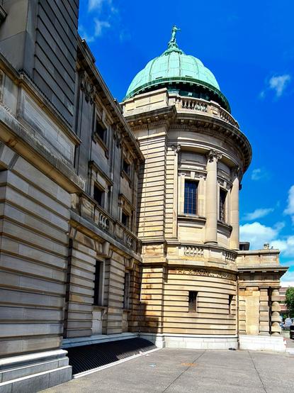 A large Edwardian Baroque building topped by a verdigris-covered dome.