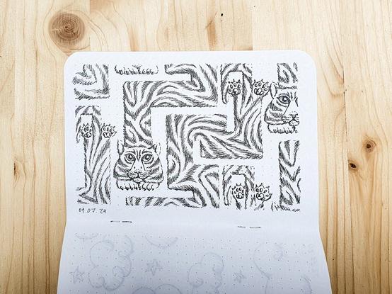 Sketchbook on a wooden surface. Inkpen sketch of a seamless pattern of a tiger with a long body winding and zigzagging.