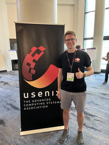 Me in front of the Usenix banner at OSDI/ATC 2024
