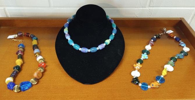 Necklaces, some featuring flamework enamel colors, featuring my handmade hot glass beads at the Athens Hot Glass shop in Athens Ohio.