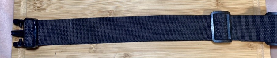 Left side section of a compound utility belt designed for concealed carry of a firearm. The belt is made from 1.5" polyester webbing and 1.5" polyester and latex rubber elastic banding, with plastic buckles. The center back section is 7" wide, constructed of four layers of elastic between two plastic tri-glide buckles, and secured in the center with a thrid tri-glide. Attached to each side is a section of webbing secured with additional tri-glides. Each side has a double layer of webbing threaded through the main buckle half, and secured to the center back section with a tri-glide buckle. The double layer provides additional stiffness for a holster wing.