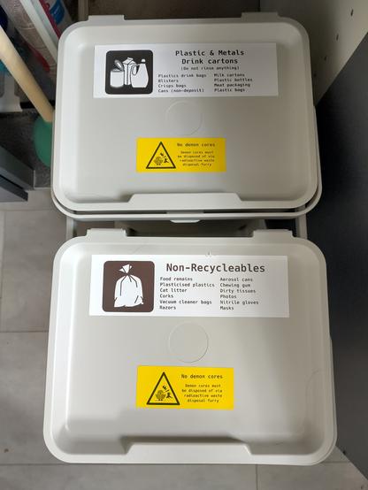 PMD and non-recyclables bins on a cupboard pull out contraption, with labelling what to throw where

additionally both labelled:

No demon cores
Demon cores must be disposed via radioactive waste disposal furry