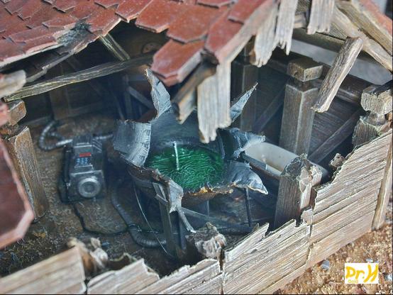 The ruptured storage tank, peeled open in an explosion that blew out this portion of the hut's wall.