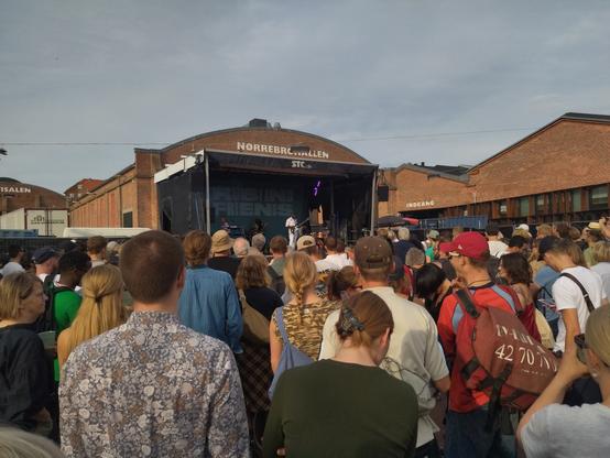 Band on stage and a crowd of people between me and them