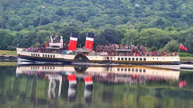 A paddle steamer sailing down the Clyde Estuary near Glasgow.