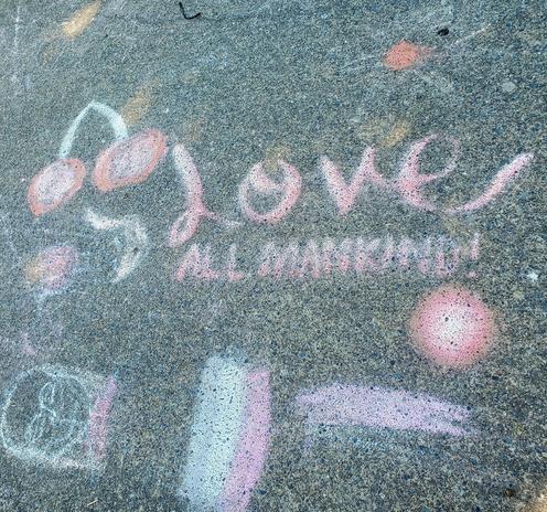 Sidewalk chalk art with cherries & text that reads: LOVE ALL MANKIND