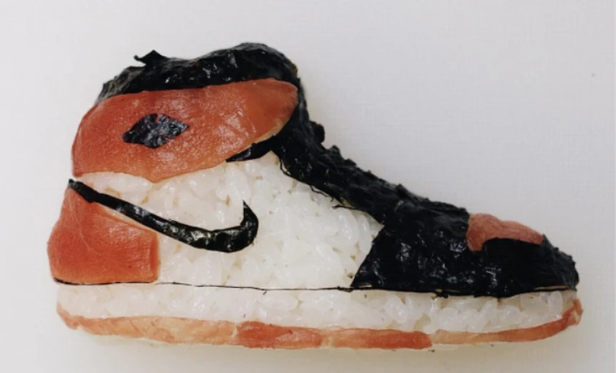 Sushi shaped like a Nike sneaker.
You can see the rice shaped like a shoe, with colour details added in the form of what I suspect is salmon, and the black Nike 'swoosh' logo, laces and other details with nori seaweed, I guess.