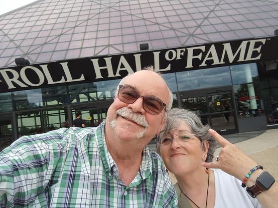 a picture of a couple of gen-xers in front of the Rock Hall of Fame.
yes we have gray hair.