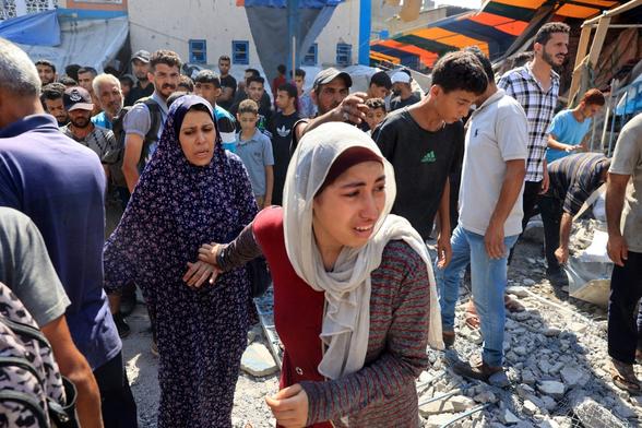A Palestinian woman reacts after the Israeli military bombardment of the UNRWA (United Nations Relief and Works Agency for Palestine Refugees) run Abu Araban school, turned shelter, where internally displaced Palestinians are living, in the Nuseirat refugee camp, in the central Gaza Strip on July 14, 2024, amid the ongoing conflict between Israel and the Palestinian Hamas militant group. Agence France-Presse