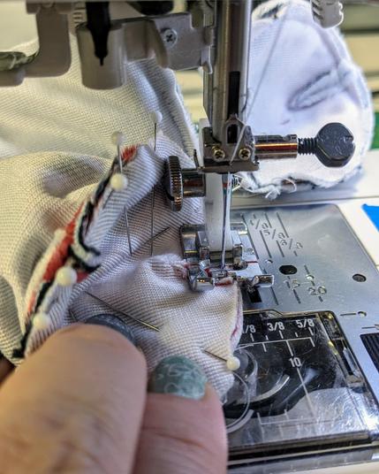 a close up shot of plush shells getting stitched on a sewing machine