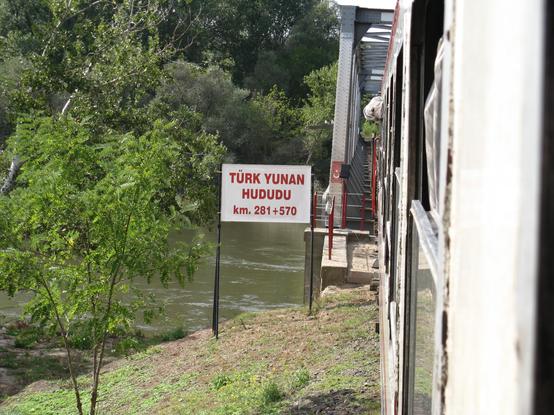 The train crossing the Evros via a bridge. A sign says "Türk Yuno hududu", Turkish-greek border. The picture was taken from the train window.