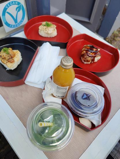 Aburi onigiri (tuna, eel and karaage) presented on separate plates, mikan juice, coffee jelly and matcha latte presented on a table. We had to sit outside as it was pretty busy.