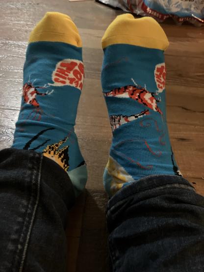 Pair of colorful socks with a shrimp saying “you’ve got this”