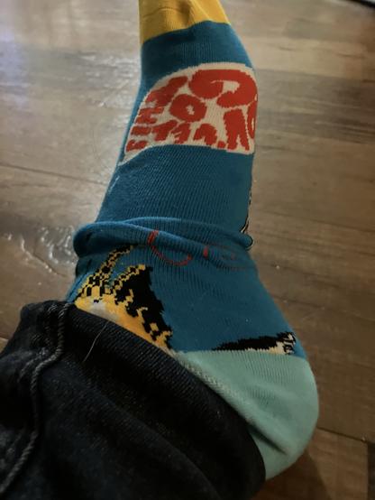 Cool socks with a world bubble saying “you’ve got this”