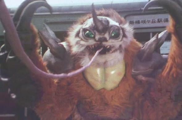 A brown sloth monster with a white face, raising his huge black claws triumphantly in the air as an off-screen hero is snared by his long tongue.