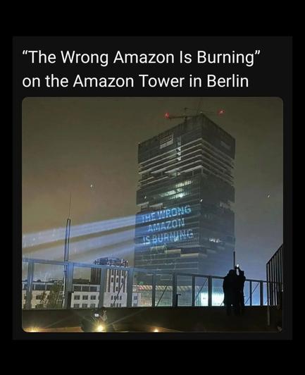 The wrong amazon is burning projected on the Amazon tower in Berlin for Prime Day