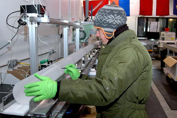 A science technician measures a section of the WAIS Divide ice core as it begins its journey down a core processing line. Scientists and technicians will cut the ice so it can be sent to labs around the country for analysis.  Credit: Peter Rejcek, NSF