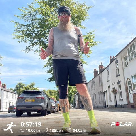 Post run selfie with run stats showing distance 10k duration 57:19 max hr 185bpm max pace 4:02 min/km