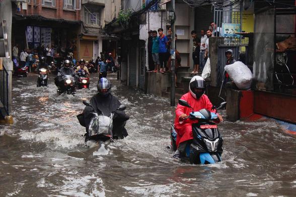 photo - scooters riding in flooded streets, Kathmandu, Nepal