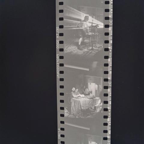 Inverted photo of a strip of black and white 135 film drying