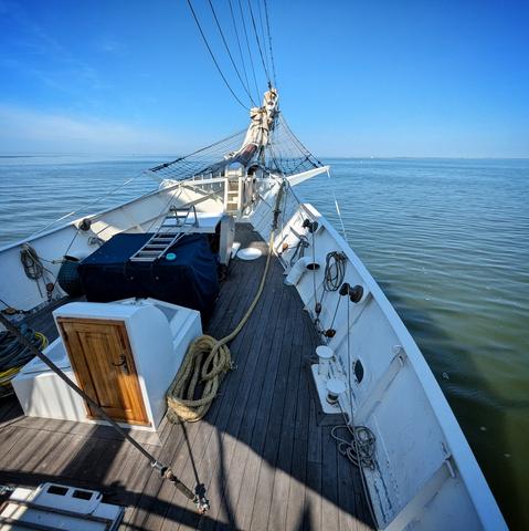view of the bow of a sailing ship on a sunny day