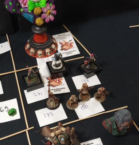 A few of some of my miniatures on a competition display. One of them has a "Commended entry" paper tag under it.