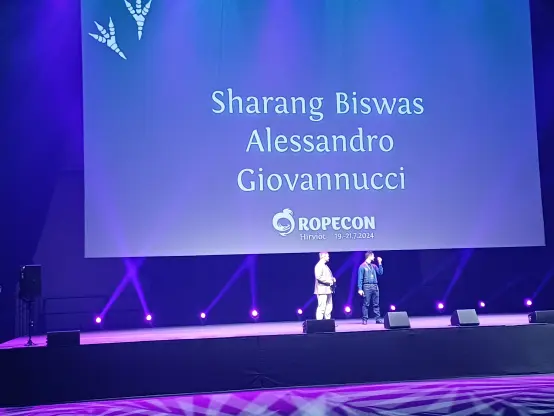 Sharang Biswas and Alessandro Giovannucci at Ropecon stage with the host.