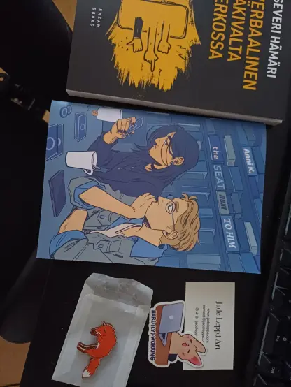 Stuff I bought. A book, a comic book, a fox fridge magnet and a sticker.