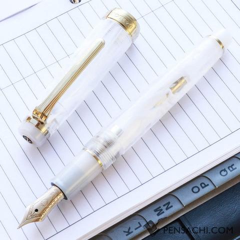fountain pen with gold trim and a swirling translucent white body