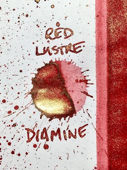red ink splat with gold shimmer
