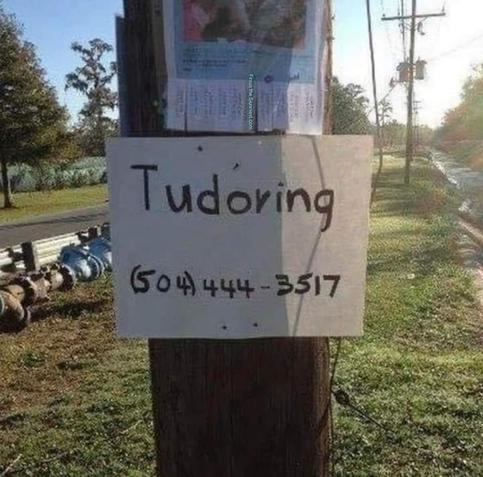 A hand-made sign tacked to a utility pole. The sign reads simply 

"Tudoring - (504) 444-3517 "

 (The word is incorrectly spelled like the English T-U-D-O-R family, and not correctly as T-U-T-O-R .)
