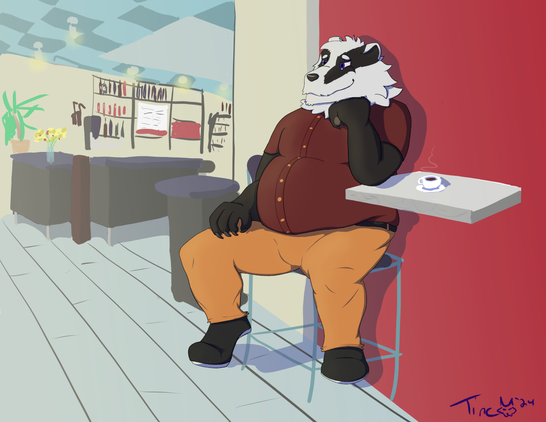 Misha the badger sitting in a cafe, dressed in burnt orange pants and a maroon button-up short-sleeve shirt. He's looking left outside the window (not pictured) with a content look on his face while resting his head on his hand with his elbow on the table. A hot cup of coffee sits by.