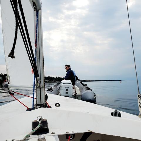 Our sailboat being towed out by Zodiac boat.