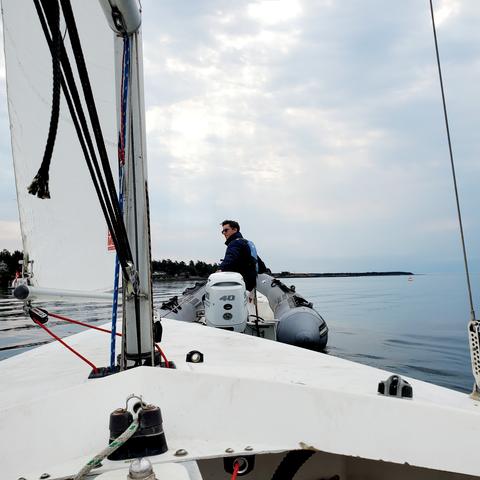Our sailboat being towed out by Zodiac boat.