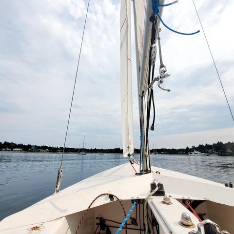 My front seat in Martin 16 sailboat view of harbour with anchored boats floating around.