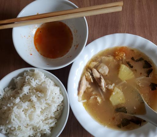 Bowl of steamed rice. Bowl of sweet n sour fish/tomatoes/pineapple soup & chili nuoc cham sauce.