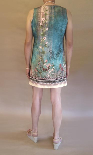 I’m wearing a blue-green and beige summer dress and beige wedge heeled sandals. Viewed from the back you can also see I’m wearing silver pearls and bright red nail polish.