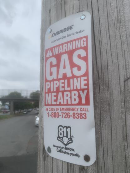 Small sign saying “warning! Gas pipeline nearby”
Nailed to a telephone poll