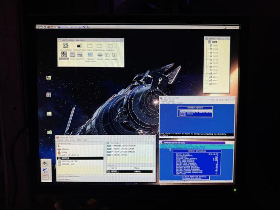 Screenshot (well, photo) of server; shows OS/2 desktop with the NetWare server in one window, the NWADMIN tool in a DOS box, NetWare Tools for OS/2 in a third window, and a Babylon 5 wallpaper.