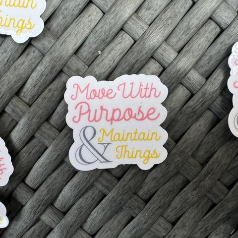Sticker with the text "Move With Purpose & Maintain Things" on a woven gray surface.