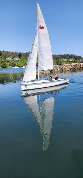 Me & instructor in Martin 16 sailboat. I'm working the sails & steering stick to get us back to the docks.