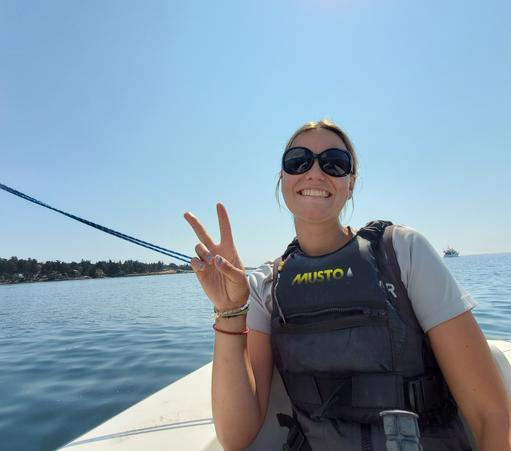 My female sailing instructor, in rear seat of Martin 16 sailboat.