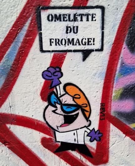 Streetartwall. A little character from the animated series "Dexter's Laboratory" has been sprayed on a street wall with Graffitis. Dexter has red hair, blue lab goggles, wears a white lab coat, purple gloves and black boots. With his mouth wide open, he shouts: "Omelette du Fromage!".
Info: Dexter's Laboratory is an American animated series from 1996-2003 about Dexter, a highly intelligent boy aged 8 to 10 who has a huge secret laboratory in his parents' house. In one episode, he has forgotten to learn French for a test and uses an invention that is supposed to allow him to do so in his sleep. However, the device's record only plays the phrase "Omelette du fromage", which is the only thing Dexter can say.